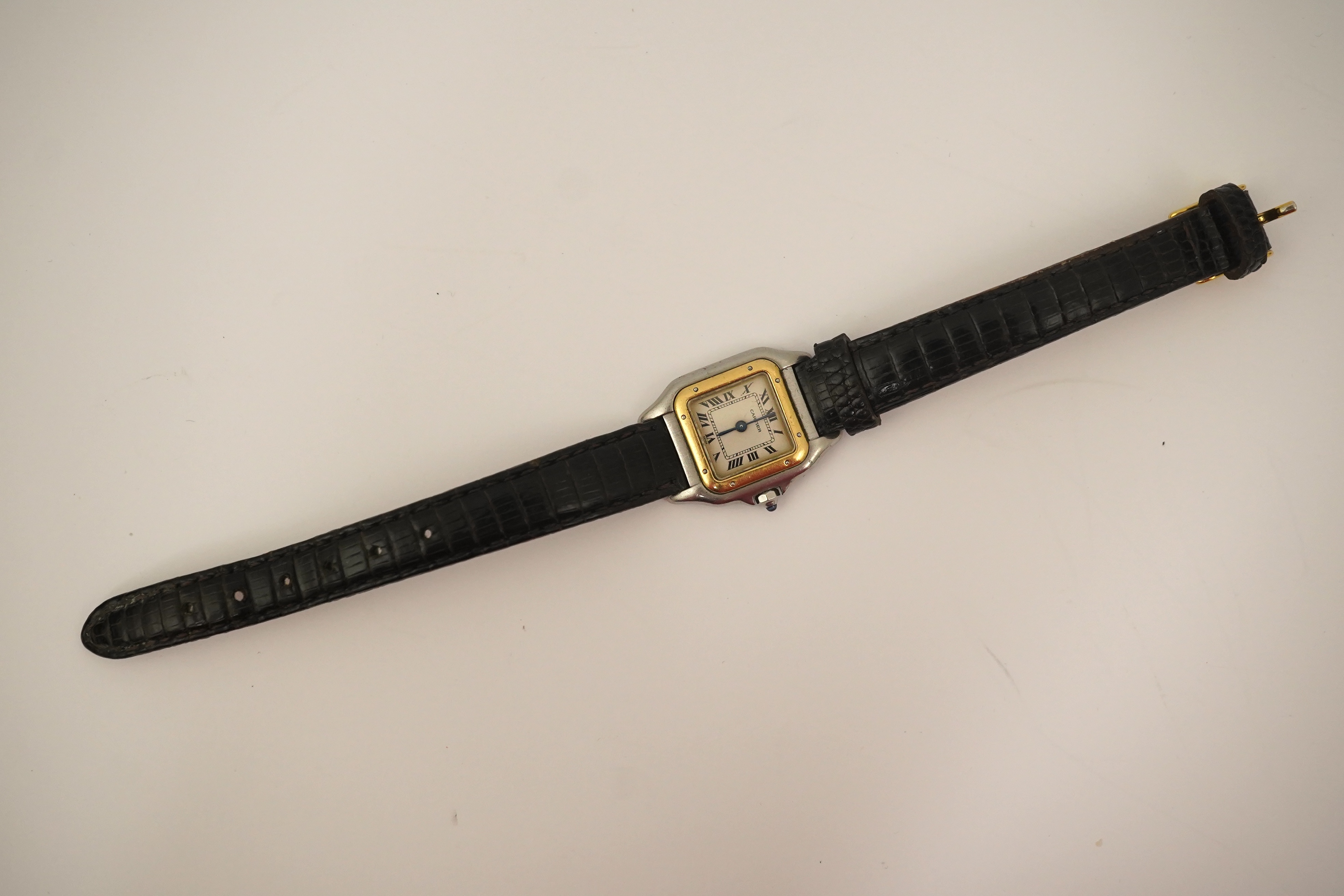 A lady's steel and gold Cartier Panthere quartz wrist watch, now on an associated leather strap, but with original Cartier steel and gold bracelet (lacking end bars)